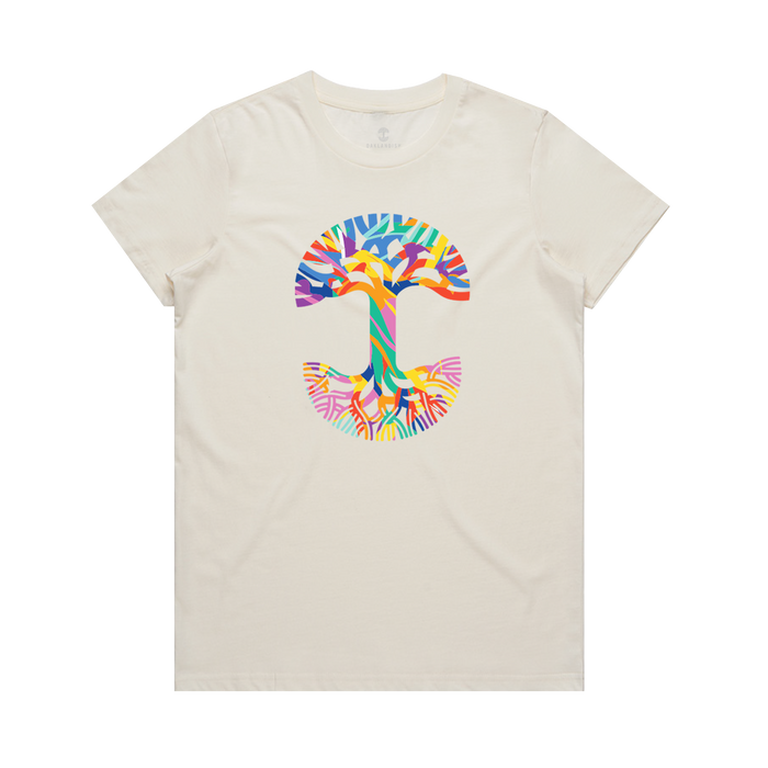 The Women's Urban Tropics Tee by Oaklandish is a cream-colored shirt with a bold abstract "T" on the chest, showcasing Kalani Ware’s vibrant multicultural design in blue, orange, yellow, green, pink, and purple hues.