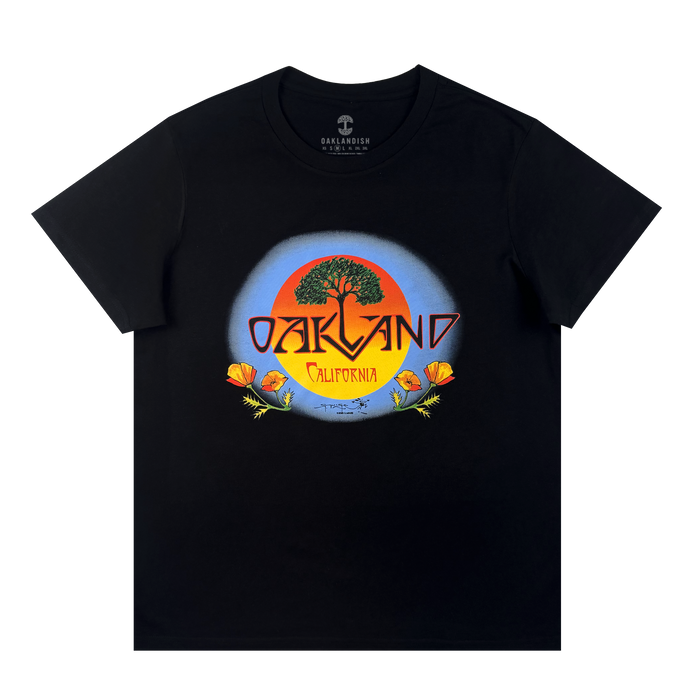The Oaklandish Women's Vanguard Tee is a cotton t-shirt with a bold tree, orange sun, and poppy flowers graphic. "Oakland" stands over "California" in yellow inside a blue circle, inspired by Stanley Mouse art.