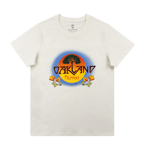 The Oaklandish Women's Vanguard Tee is a classic fit featuring a round sunset graphic with a black tree, bold "OAKLAND," "California" below, and orange poppies framing the border.