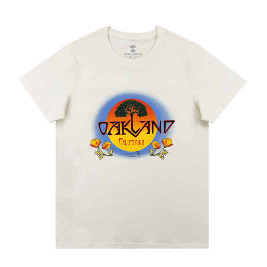 The Oaklandish Women's Vanguard Tee is a classic fit featuring a round sunset graphic with a black tree, bold "OAKLAND," "California" below, and orange poppies framing the border.