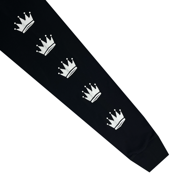 The Oaklandish WPBA Core LS Tee features a black sleeve adorned with a vertical pattern of six evenly spaced, white crowns. Each crown has a small horizontal base and five points with circular tips. Empowerment radiates from the ribbed cuff at the bottom of this distinctive women's sports tee design.