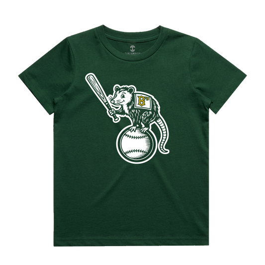 The Oakland Ballers Youth Clutch Tee is a dark green t-shirt showcasing a cartoon opossum wearing a vest with a yellow-detailed white “B,” standing proudly on a large baseball and holding a bat—a fun tribute to the pro baseball team.